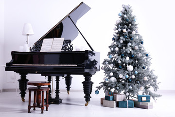Grand piano in room decorated for Christmas