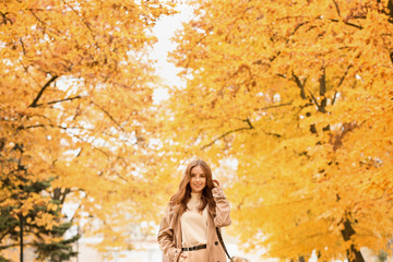 Portrait of stylish young woman in autumn park