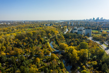 Fototapeta premium Warsaw, Poland. 20. August. 2019. Aerial view of the cityscape with streets and public transport. Drone flies towards buildings and skyscrapers in the city.