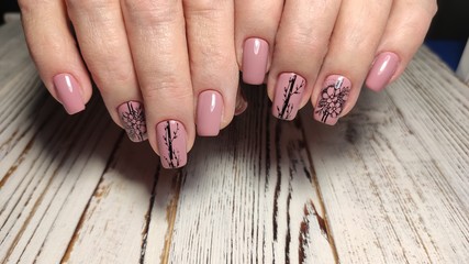 fashionable beige manicure with a silver design