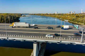 Highway passes through the river and leads to the center of Warsaw, Poland.  15. October. 2019. Aerial view of traffic jams on an automobile bridge with many vans and cars.