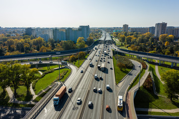 Aerial shot of  big freeway intersection in Warsaw, traffic going fast through many road flyovers....