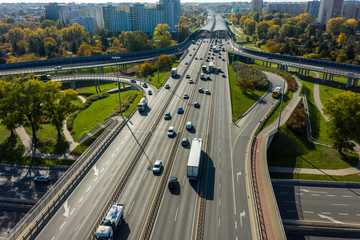 Aerial shot of  big freeway intersection in Warsaw, traffic going fast through many road flyovers. Poland. 30. October. 2019. Aerial view of a motorway with several traffic intersections.