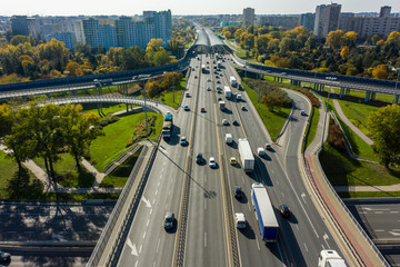 Drone shot at a highway with a clover junction with bridges and ramps, heavy traffic. Warsaw,...
