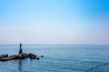 Famous bay statue of a girl holding a seagull in Town of Opatija, Kvarner bay of Croatia