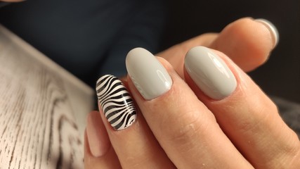 fashionable beige manicure with a silver design