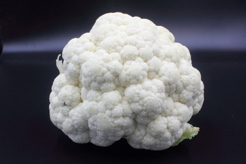 fresh cauliflower on black background