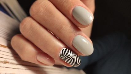 fashionable beige manicure with a silver design