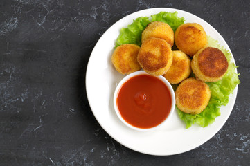 breaded fried potato balls with tomato sauce