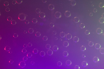 Macrophotography of air bubbles on the wall and bottom of a glass and pieces of ice in a soda...