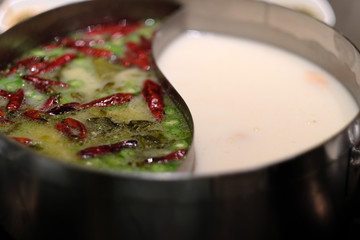 close up traditional Chinese double-flavor hot pot. blur background