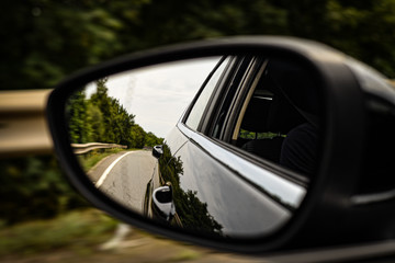 Car wing mirror reflection driving. 