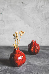 Pomegranate vase on a gray background. Vintage style