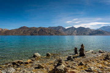 Fototapeta na wymiar Stone stacked on the bank of Pangong Lake or Pangong Tso in Ladakh, India 