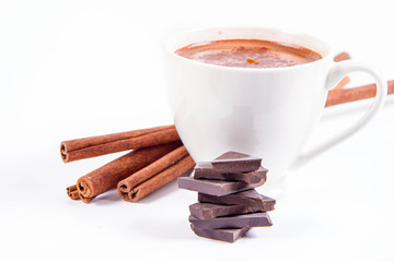 Cup of hot chocolate with cinnamon and pieces of dark chocolate 