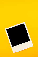 photo with the image of a black square lies on a yellow background.