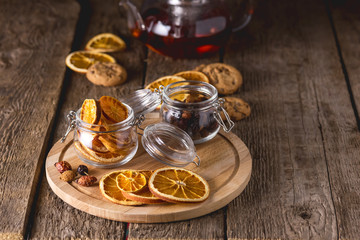 Glass Jars of Dried Citrus and Berry for Tea Ingredients for Tasty Hot Beverage Wooden Tray Wooden Background Dried Oranges Horizontal Copy Space