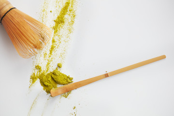 Matcha green tea powder view from above, traditional matcha tea preparing , white background. Flat lay 