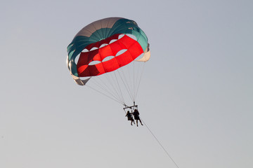 paragliding in the sky over the blue sea