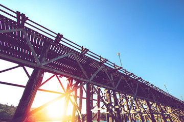 Fototapeta premium under wooden bridge over river in the morning at Sangkhlaburi, Kanchanauri province, Thailand