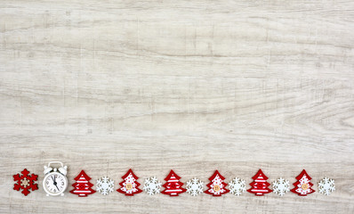 Christmas decorations. White and red snowflakes, clock, tree silhouette with space for text. Top view, flat lay