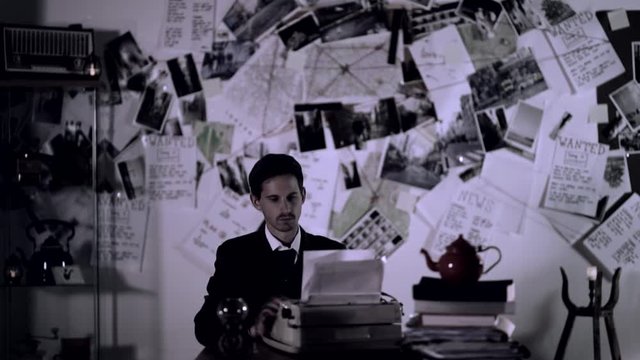 Hard Working Detective Typing on Old Typewriter at Dark Night. 