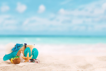 Summer background with accessories for beach holidays. tropical landscape with sand in the foreground and blurred background. concept of summer vacation in hot destinations - warm contrast filter