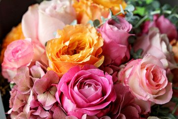 Close up of beautiful colourful bouquet of pink and yellow roses and hydrangeas flowers. Natural floral background. Bright and multicoloured mix of flowers.