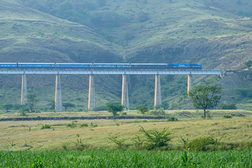 Pune, India - October 20 2019: A passenger train amidst greenery at Kamshet near Pune India.