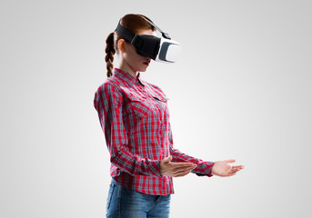 Girl in mask experiencing virtual reality as new entertainment device