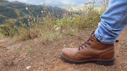 Leather boot used in mountain trekking. High altitude adventure sports.