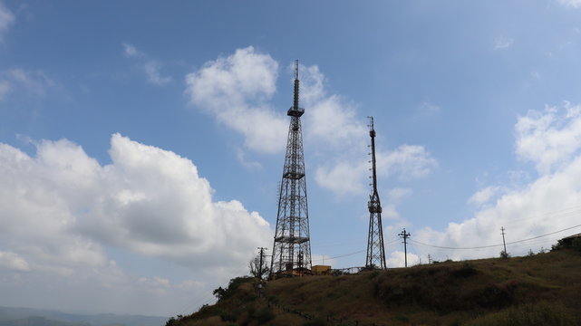 Mobile tower standing on the mountain top with clear sky. Telecom company powered mobile communication.