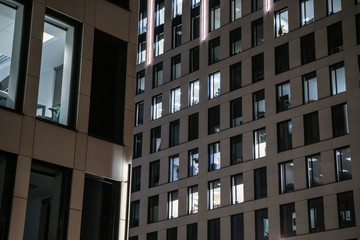 Office buildings, modern glass and concrete silhouettes of skyscrapers. Working overtime at night.