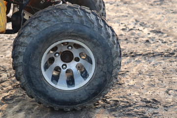 Fototapeta na wymiar Black rubber tyre of a small tractor or car.