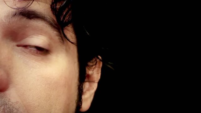 The face of a weird man, feeling many different emotions (from anger to happiness). Detail front shot with copyspace.