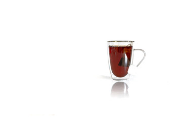 Tea in a glass mug with tea bag. Studio isolated on white background