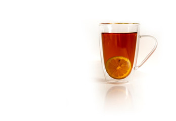 Mug of hot black tea with lemon isolated on white background