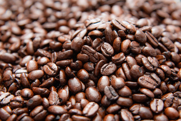 Close up pile of roasted coffee beans, shallow depth of field.