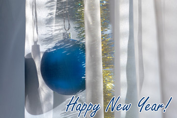  New Year decorations behind a day curtain as background and text "Happy New Year!"