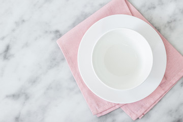 Empty black plate on dark stone background.