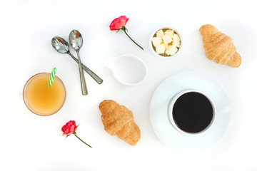 Fototapeta na wymiar Morning breakfast coffee and croissant, butter, orange juice and flowers on white background. Flat lay, top view