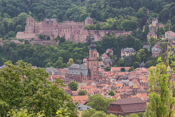 Fototapeta na wymiar Close up of Heidelberg castle with the church of the Holy Sprit seen from the Philosoph's path