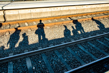 shadow of people waiting for the train