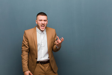 young handsome businessman looking angry, annoyed and frustrated screaming wtf or what‚Äôs...