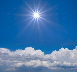 Naklejka na ściany i meble bright blue cloudy sky with sparkle sun, outdoor background