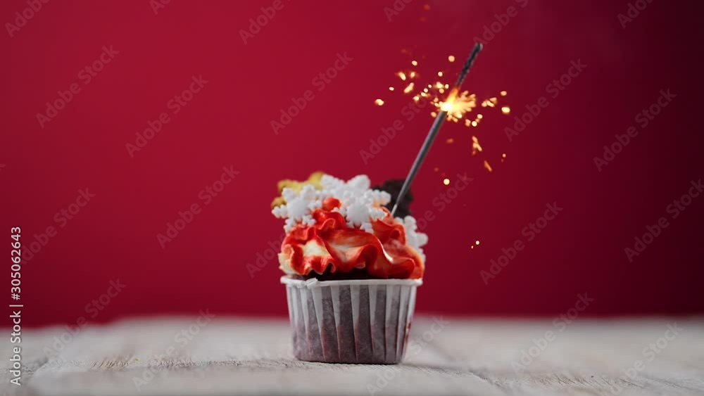 Poster cupcake on a red background with sparkler