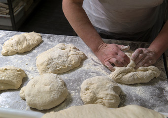 baker with dough in hands