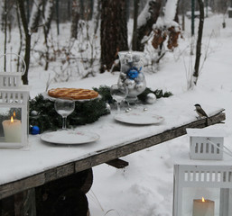 Christmas table in the winter forest