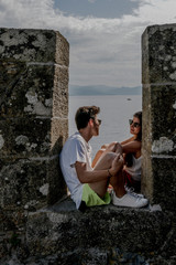 girl and boy looking at each other and enjoying the views of the sea