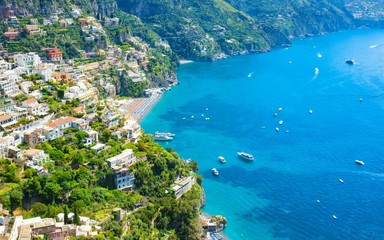 Beautiful Positano on hills leading down to coast and azure sea on Amalfi Coast in Campania, Italy. Amalfi coast is most popular travel and holiday destination in Europe.